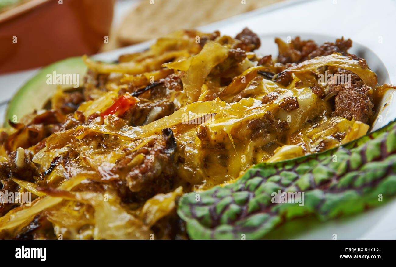 Tex Mex cavolo padella Carni bovine oppato con messicano piccante miscela di formaggio, cucina tex-mex e tradizionali piatti assortiti, vista dall'alto. Foto Stock