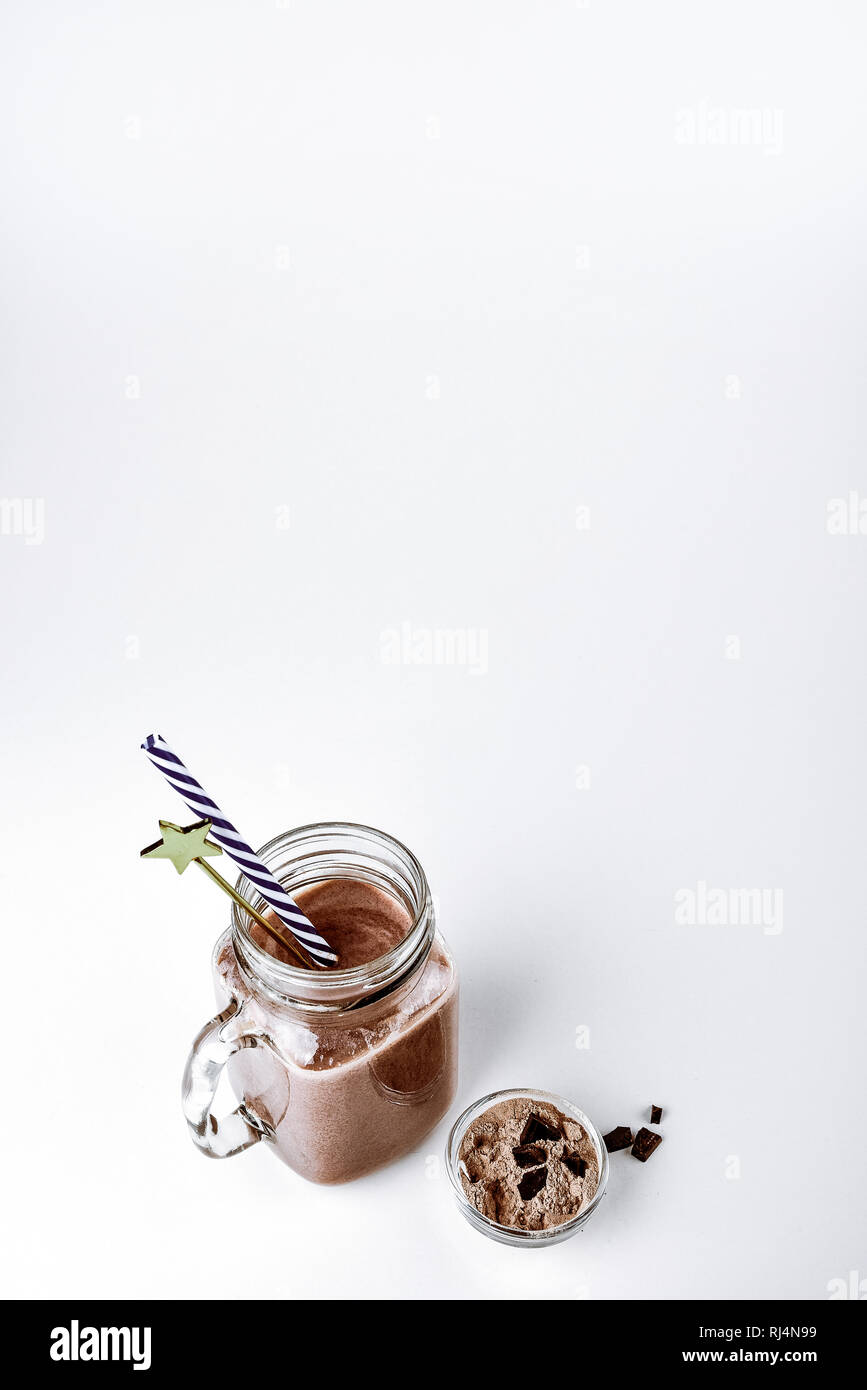 Protein Shake, smoothie con cioccolato e cacao in un recipiente su sfondo bianco Foto Stock