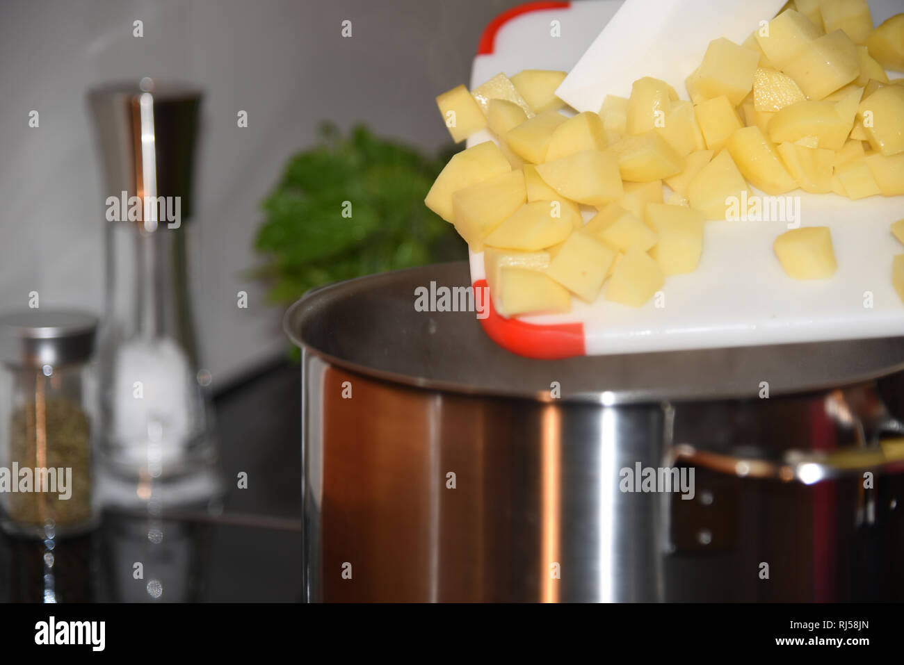 Kochplatte, Topf, Schneidebrett, Kartoffeln Foto Stock