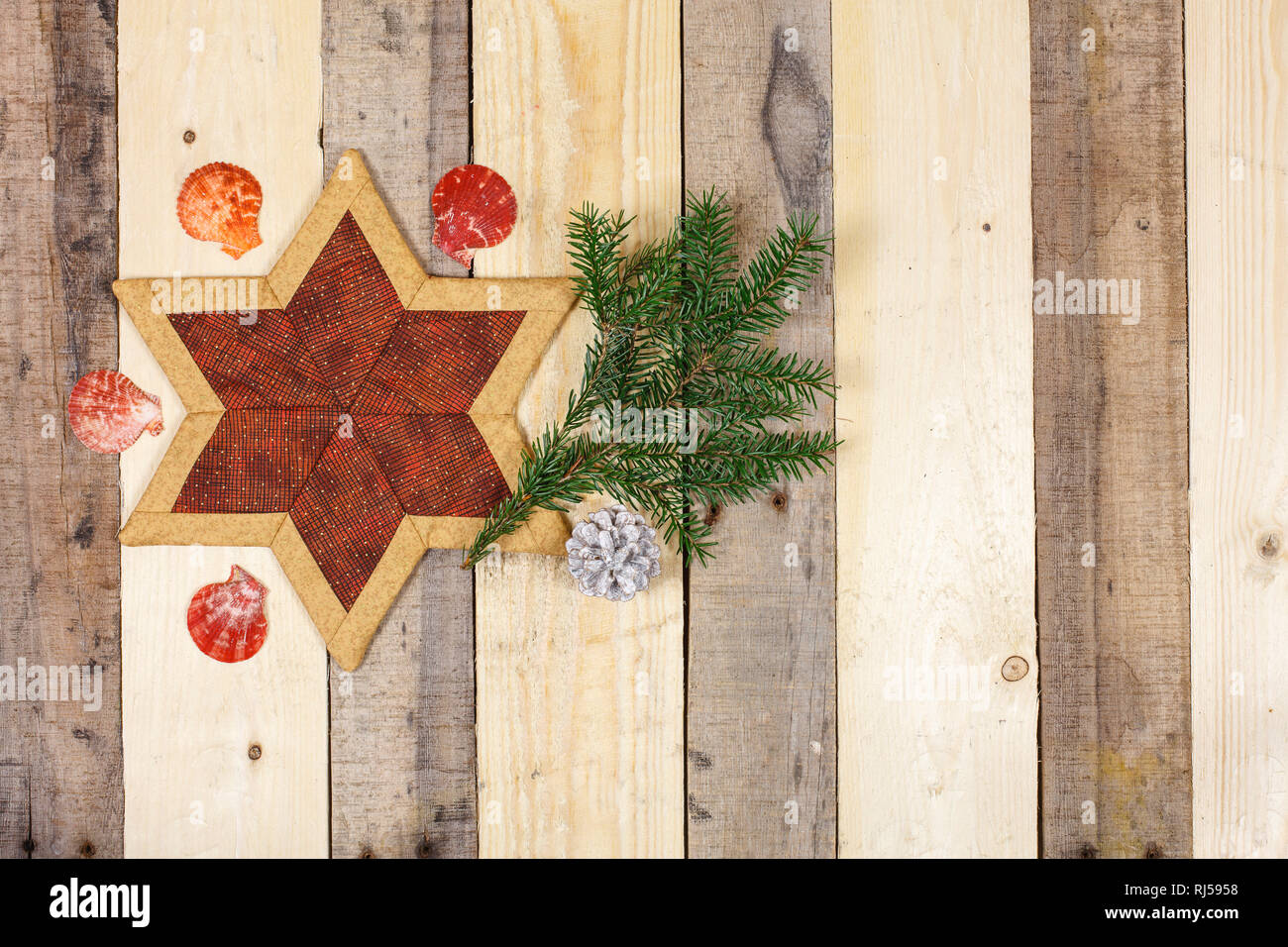 Weihnachtsdekoration, Stern aus Stoff, Zweig, Jakobsmuschel Foto Stock