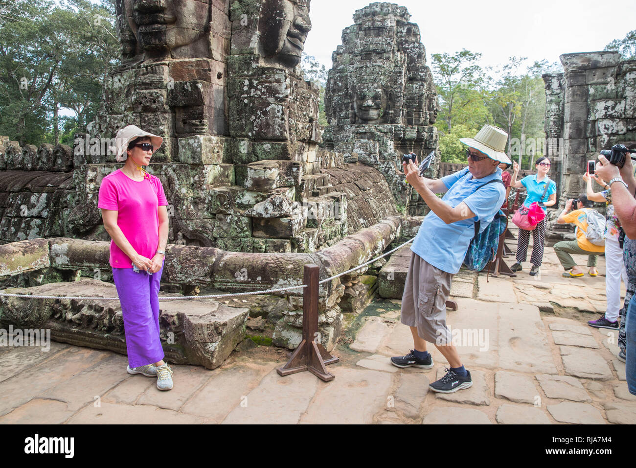 Siem Reap, Angkor, Tempel Bayon, von Touristen überlaufen, Paar beim fotografieren Foto Stock