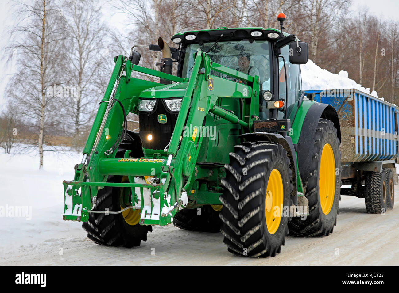 Salo, Finlandia - 2 Febbraio 2019: trattore John Deere cale snow cancellato dalle strade e parcheggi lontano dalla città di neve comunale area di dumping. Foto Stock