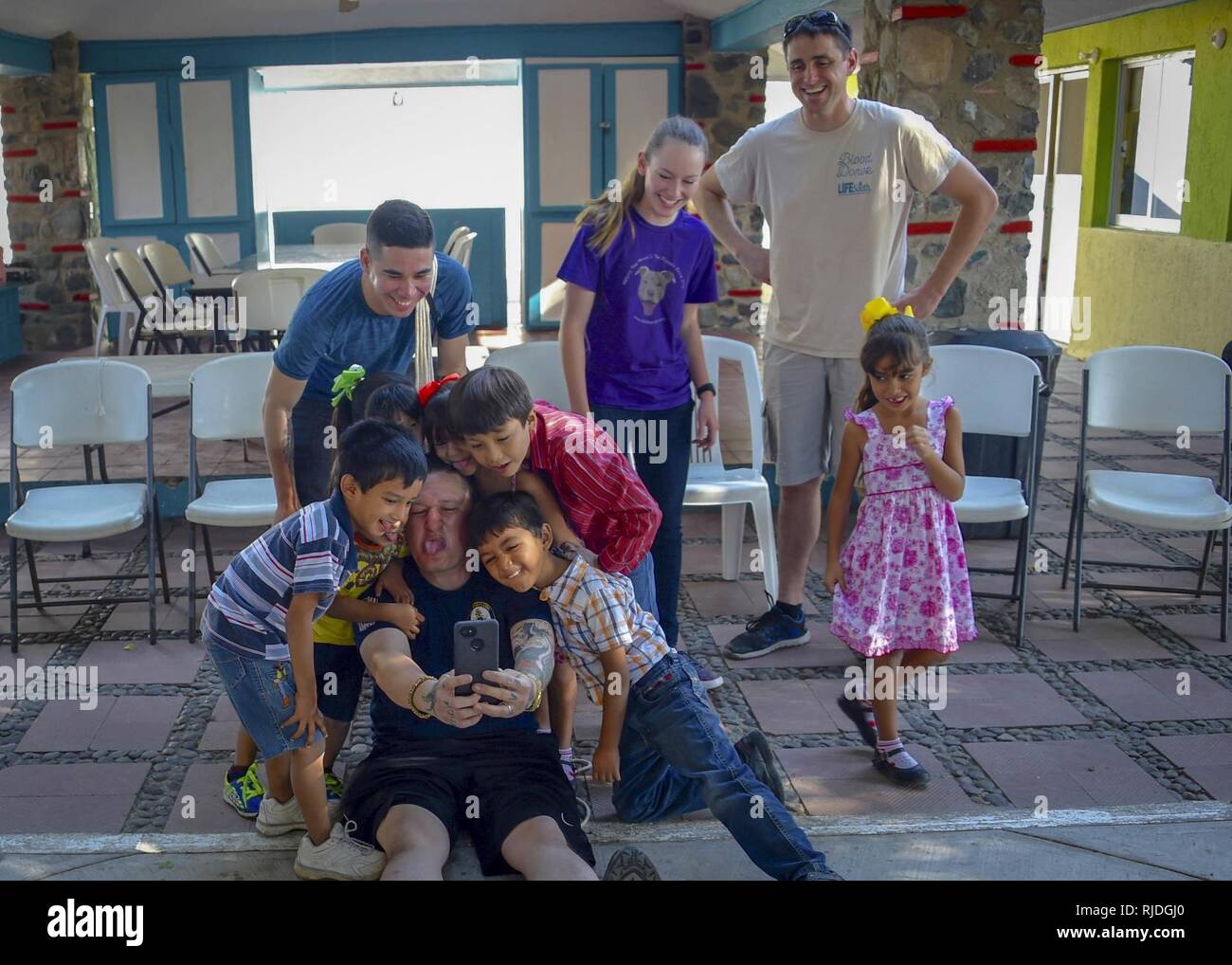 MANZANILLO, Messico. (Jan 17, 2018) velisti assegnati al futuro del trasporto anfibio dock nave USS Portland (LPD 27) posano per una foto mentre visitano i ragazzi alla Casa Hogar Los Angelitos bambini dell'orfanotrofio. Portland è in transito per loro homeport di San Diego. Foto Stock