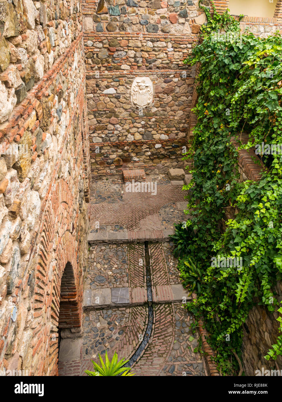 Corsia stretta e il cortile, Alcazaba palazzo fortificato di parete, Malaga, Andalusia, Spagna Foto Stock