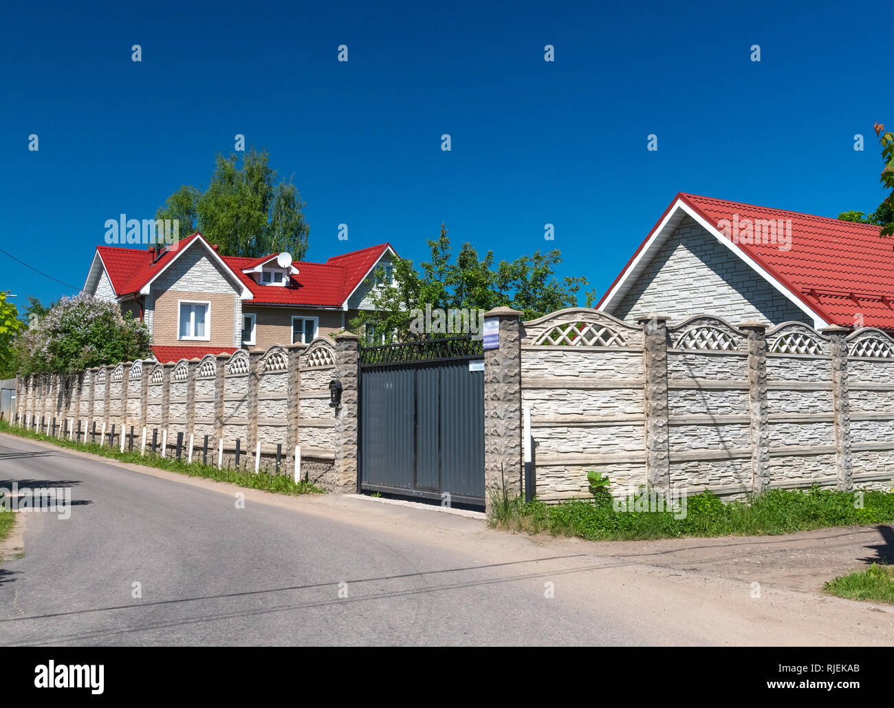 Moderno edificio privato dietro la recinzione in estate Foto Stock