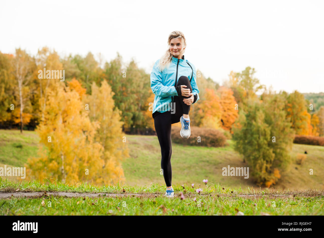 Che corre lungo un percorso di parcheggio, assistenza sanitaria e problema concetto - close-up di un infelice persona che soffre di un dolore alla gamba o al ginocchio all'aperto Foto Stock