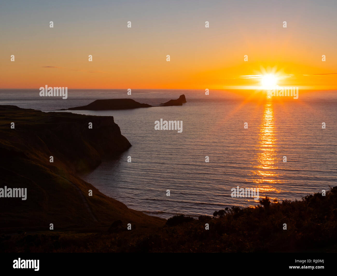 Testa di vermi Rhossili Gower Swansea in Galles al tramonto di sera Foto Stock