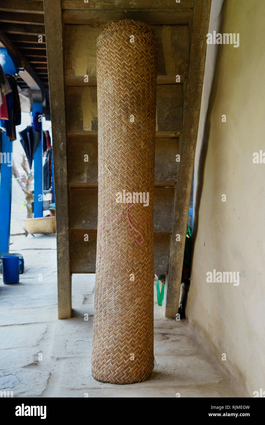 Paglia di laminato tappeto intrecciato memorizzati sotto il portico di una guesthouse nella regione di Annapurna, Nepal. Foto Stock