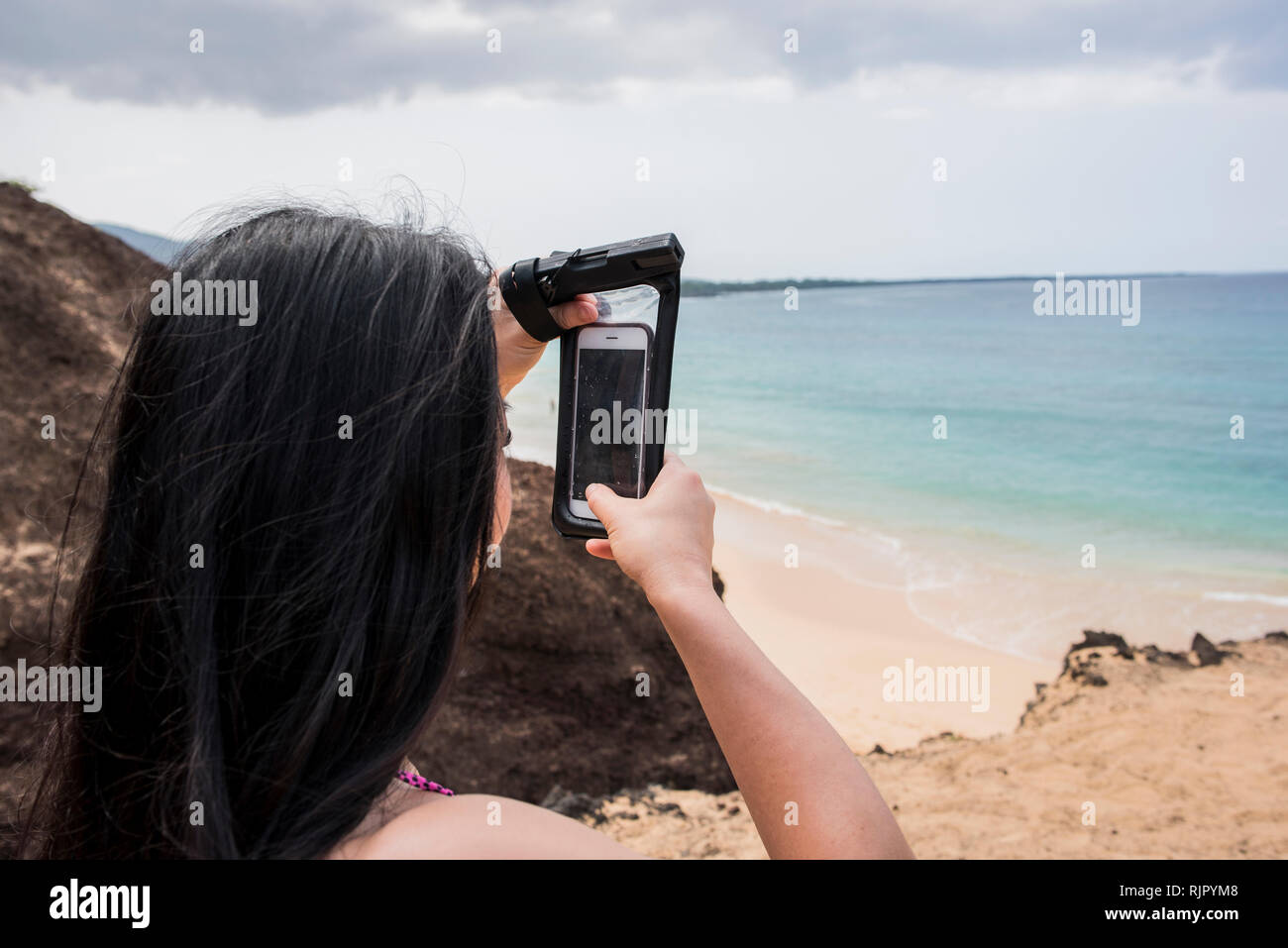 Donna prendendo foto sulla spiaggia, Makena Beach, Maui, Hawaii Foto Stock