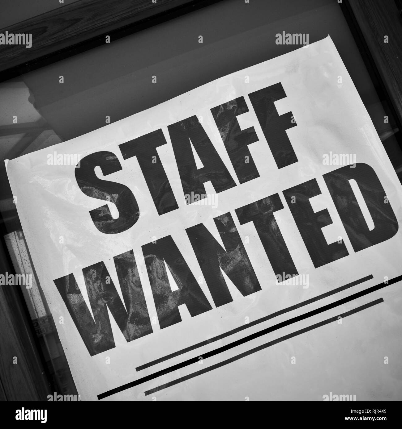 Il personale ha voluto - posto di lavoro vacante poster in una vetrina. In bianco e nero Foto Stock