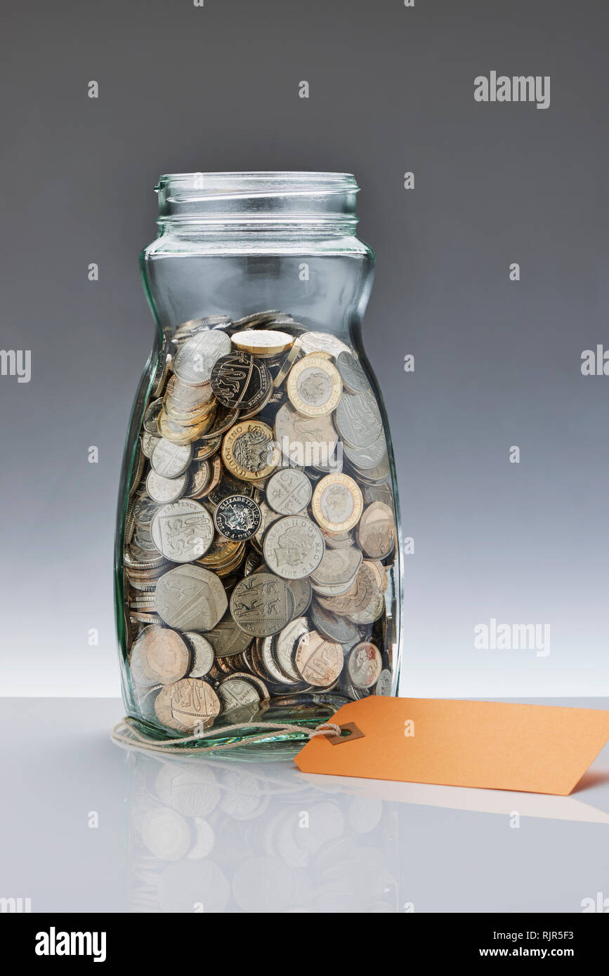 Risparmio di vetro vaso con cancelletto monete Foto Stock