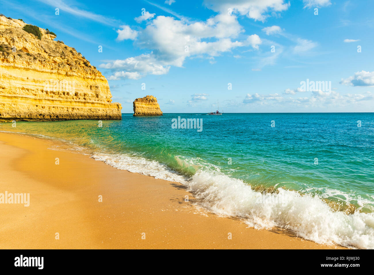 Sciabordare di onde a Sandy Beach, Praia da Marinha, Algarve, Portogallo, Europa Foto Stock