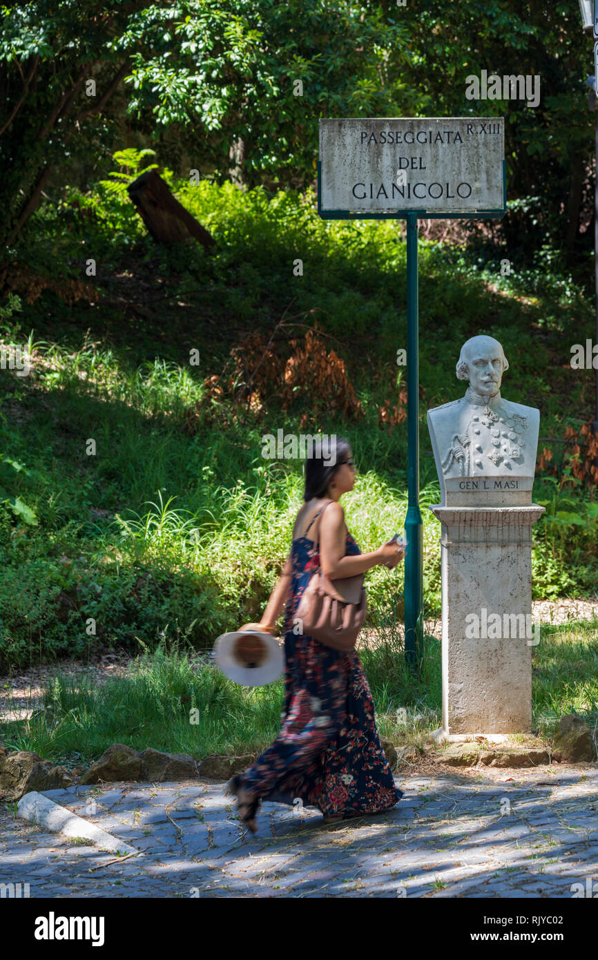 Una giovane donna entra da un busto statua del generale L Masi sul colle del Gianicolo a Roma, Italia. Foto Stock