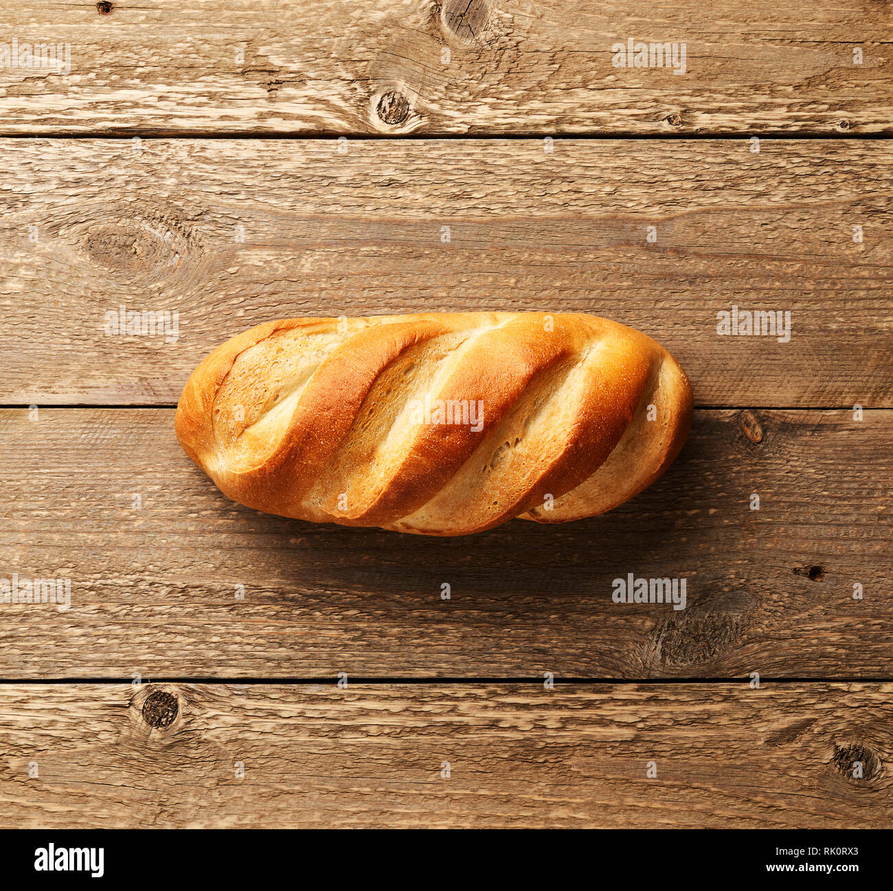 Pane bianco. Concetto di panetteria. Filone sul tavolo in legno con il posto vuoto per il design. Vista dall'alto. Foto Stock