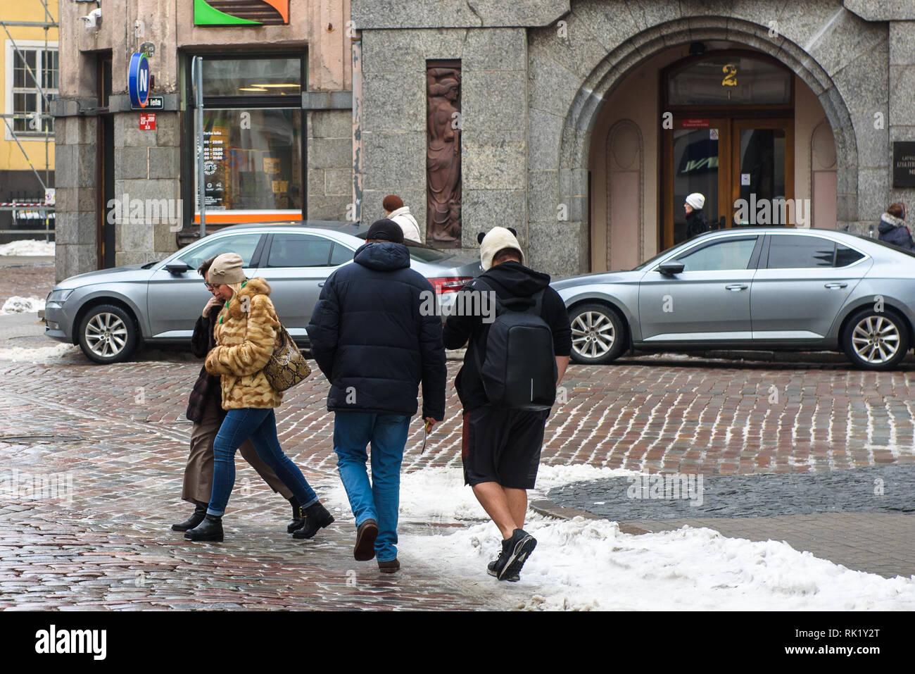 08.02.2019. RIGA, Lettonia. Giovane uomo che indossa pantaloncini, durante la passeggiata in città. L'inverno. Foto Stock