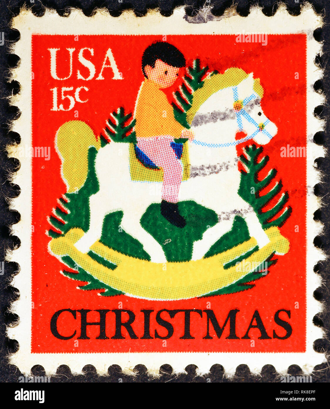 Bambino sul cavallo a dondolo in amerian francobollo Foto Stock