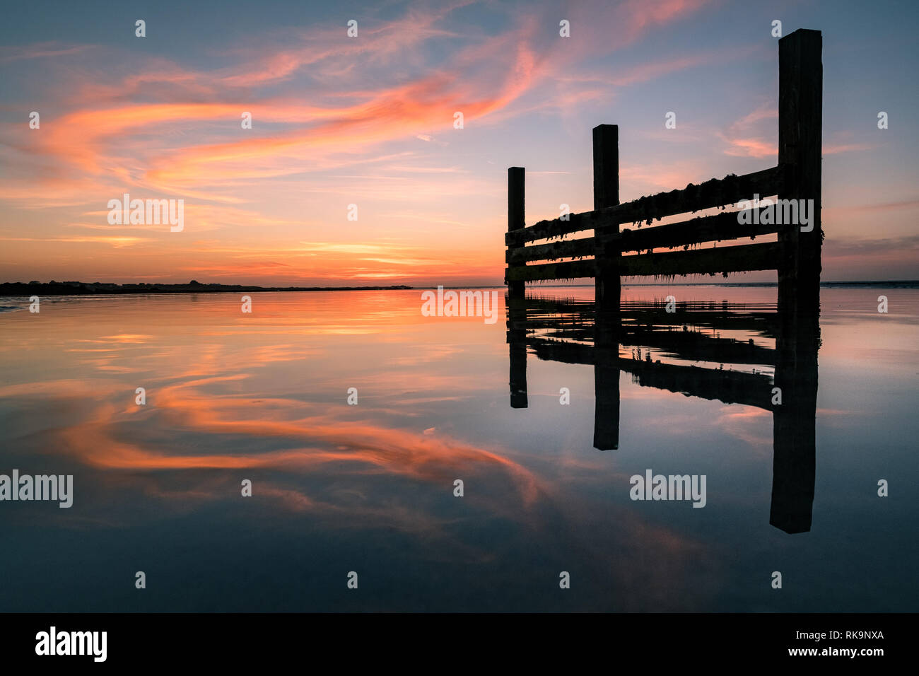 Il tramonto si riflette su una piscina d'acqua sulla spiaggia Foto Stock