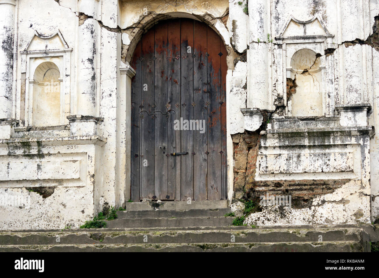La Iglesia en ruinas muy antigua, con puerta al frente desteñida, localizada muy cerca de Antigua Guatemala, ciudad colonial de mucha importancia Foto Stock