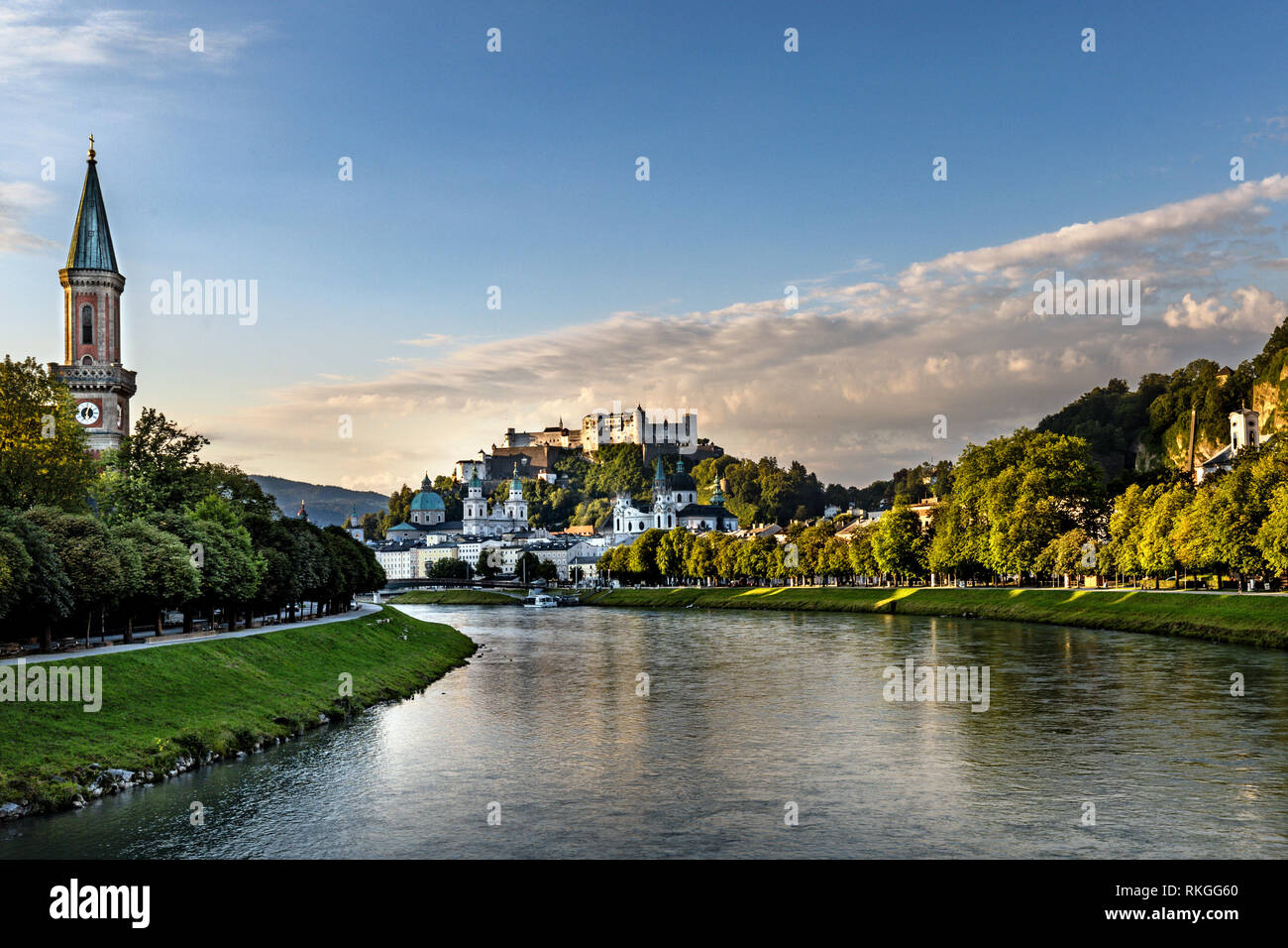 Il fiume Salzach si divide la città vecchia dalla città nuova, con la Fortezza di Hohensalzburg in distanza, Salisburgo, Austria. Foto Stock