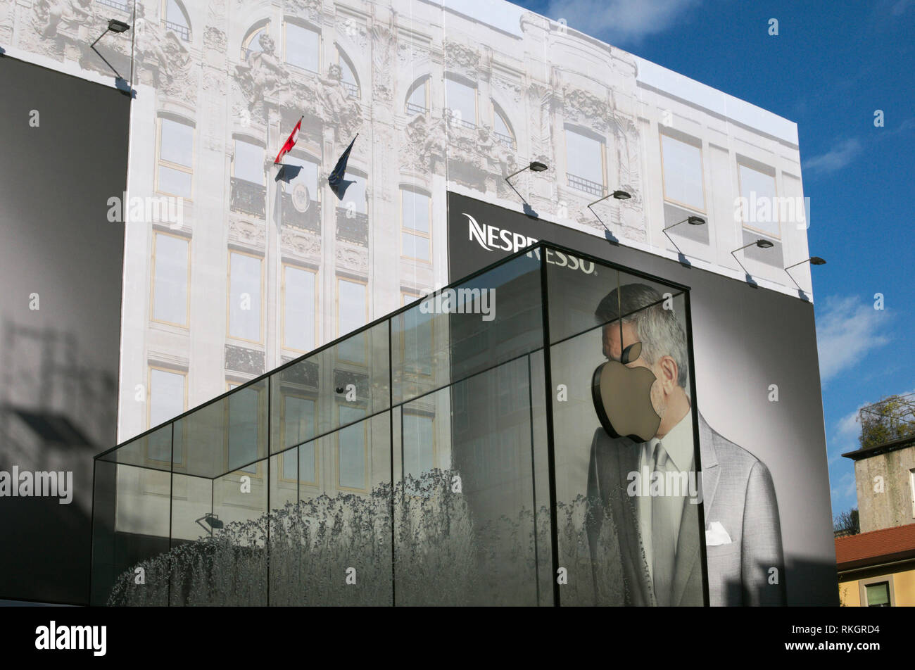 Fontana di vetro presso il negozio Apple Store in Piazza Libertà, progettato dall'architetto Norman Foster e la pubblicità sulla facciata del palazzo, Milano, Italia Foto Stock