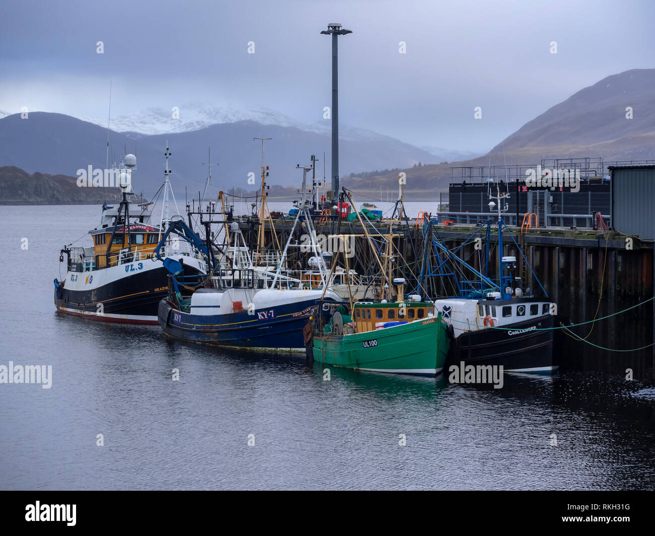 Barche da pesca ormeggiate a Ullapool Harbour in un giorno di pioggia. Ullapool, Highland, Scozia. Foto Stock