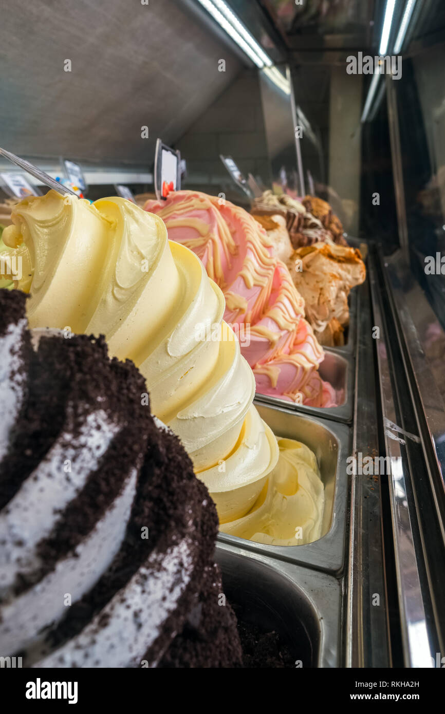 Visualizzazione di un assortimento di gelati in vasche di metallo in un negozio o gelateria close-up Foto Stock