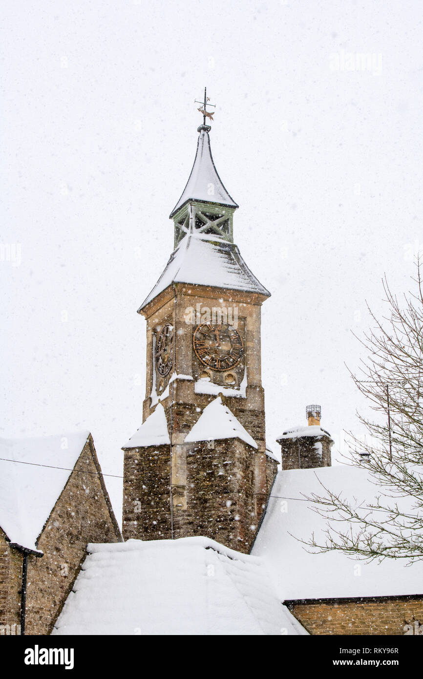 La torre dell orologio in inverno la neve. Eastleach Turville, Cotswolds, Gloucestershire, Inghilterra Foto Stock