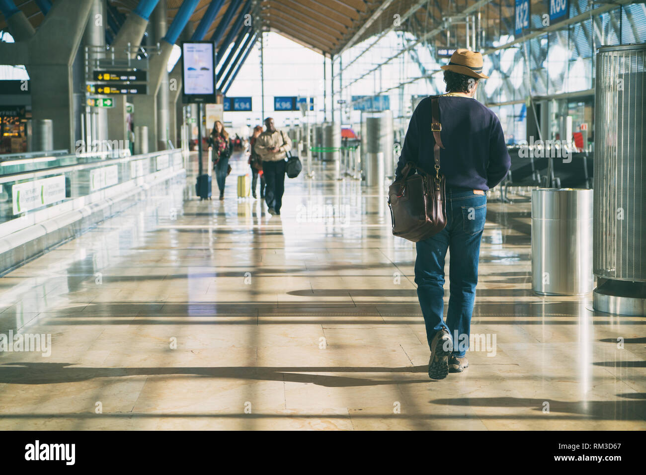 Hipster uomo che porta uno zaino mentre a piedi attraverso un passeggero terminale di partenza in aeroporto. hipster mantraveler journey travel. Foto Stock