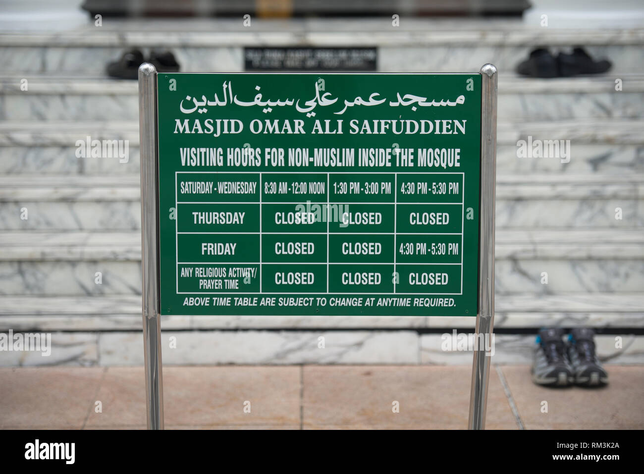 Segno della moschea, con orari di visita per i non musulmani per entrare in moschea con le scarpe su operazioni in background, Sultan Moschea di Omar Ali Saifuddien, Bandar Seri mendicare Foto Stock