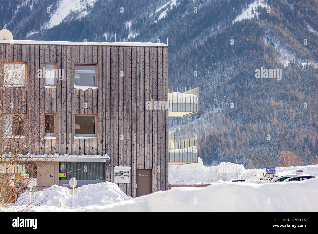 Moderna casa di montagna in inverno con montagne innevate sullo sfondo nella regione sciistica di Schladming-Dachstein, Liezen District, Stiria, Austria Foto Stock