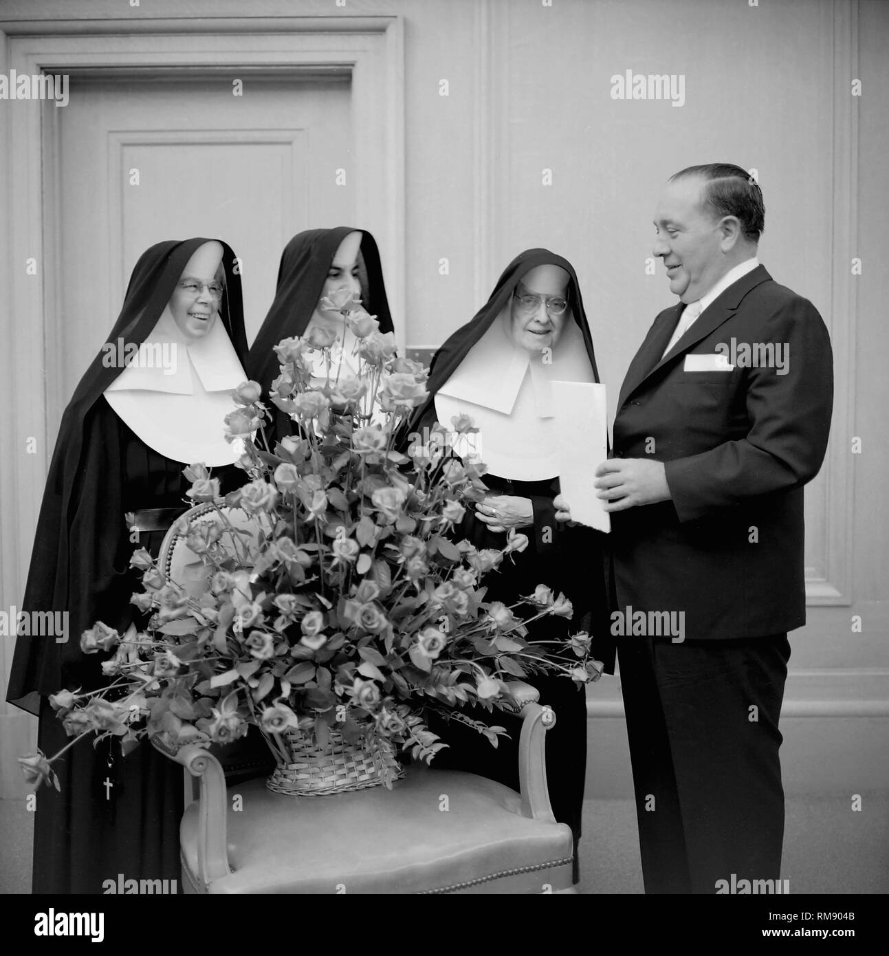 Il sindaco di Chicago Richard J.Daley presenta alcune monache un bouquet di fiori, ca. 1960. Foto Stock