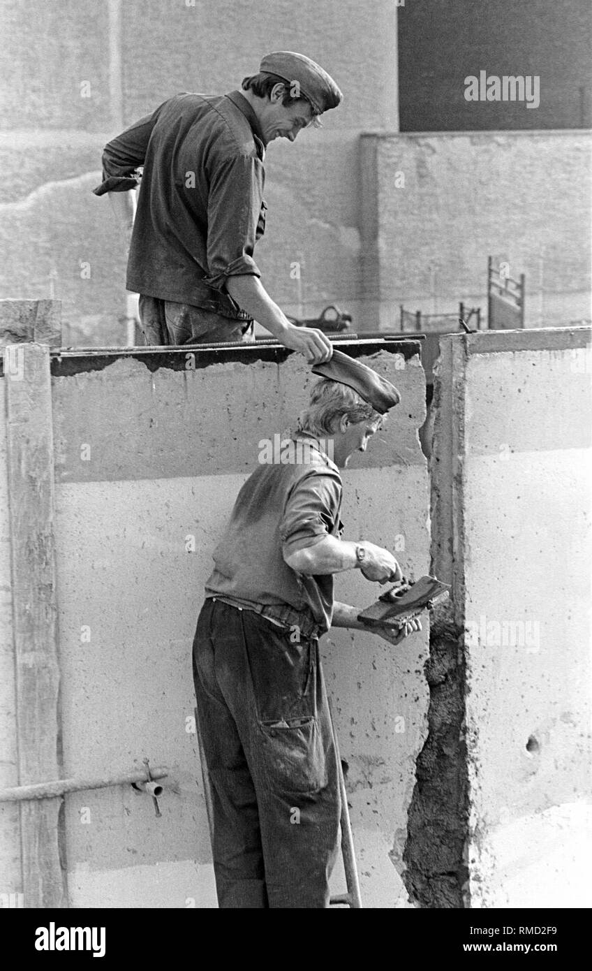 Grenzpioniere lavorando sulla modernizzazione della parete nel distretto di nozze. In agosto 1985, le autorità della RDT cominciare ad aggiornare l'ultima sezione del muro di Berlino con un oltre quattro metri di altezza parete di cemento. Foto Stock