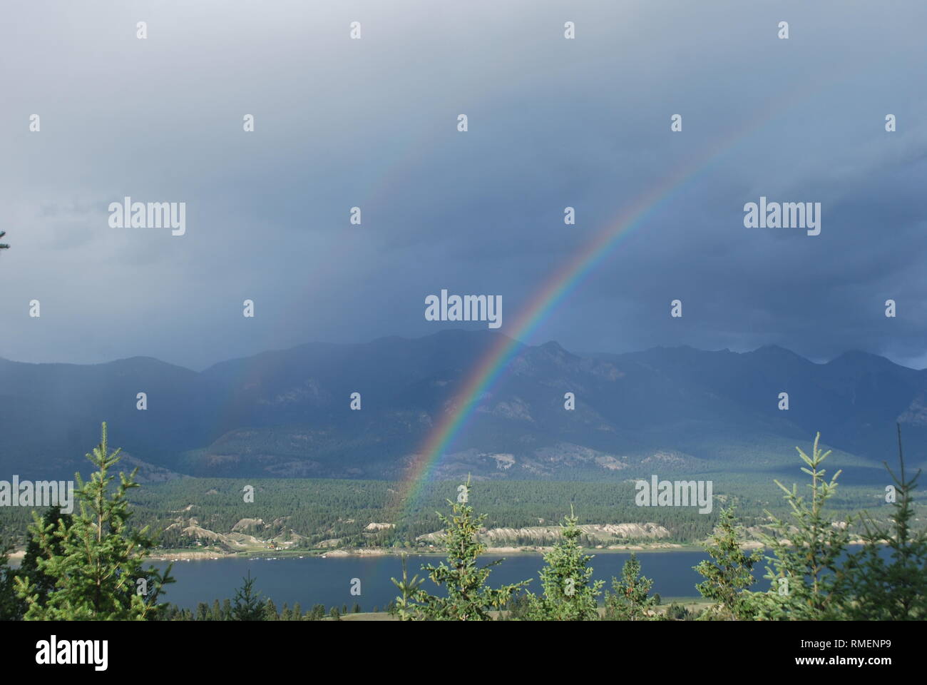 Una debole arcobaleno doppio sopra il lago di Windermere, British Columbia Foto Stock