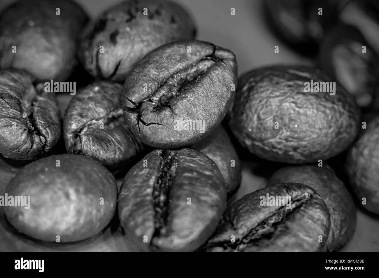 Marrone caffè torrefatto in grani su sfondo nero, close-up, macro Foto Stock