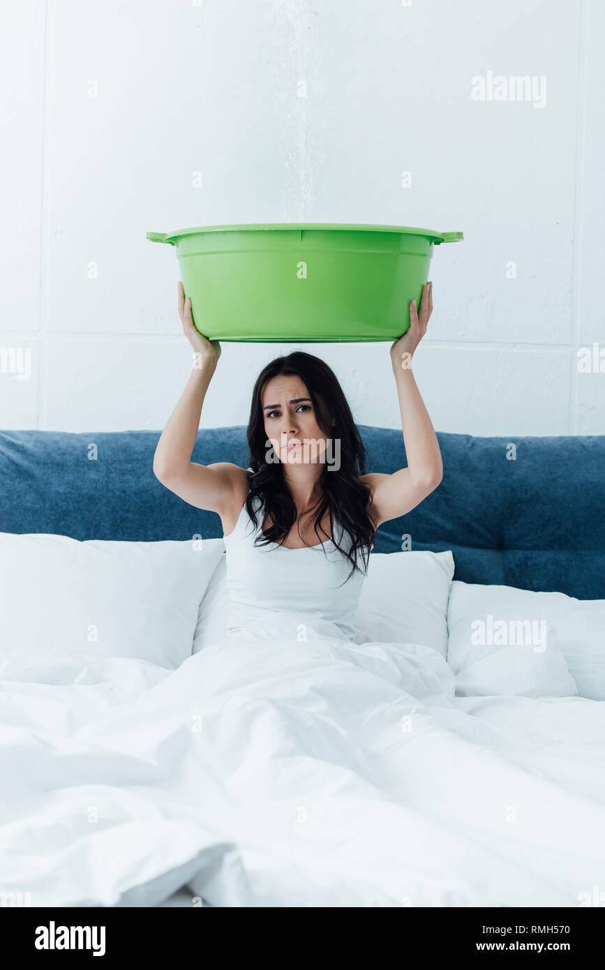 Sconvolto giovane donna bacino di contenimento durante la perdita in camera da letto Foto Stock