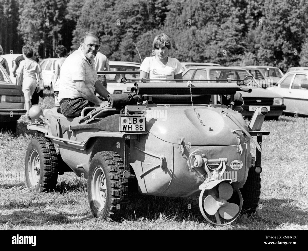 Klaus Rauser nel restaurato tipo Volkswagen Schwimmwagen 166. Rauser e sua figlia Sylke ha guidato la vettura da Fresberg am Neckar a Reit im Winkl nel 1984. Foto Stock