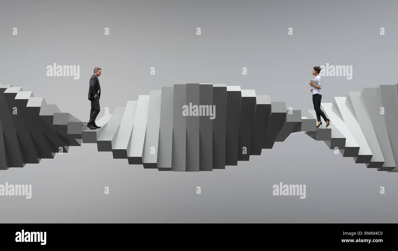 Due persone in piedi su lati opposti di una scala a spirale Foto Stock