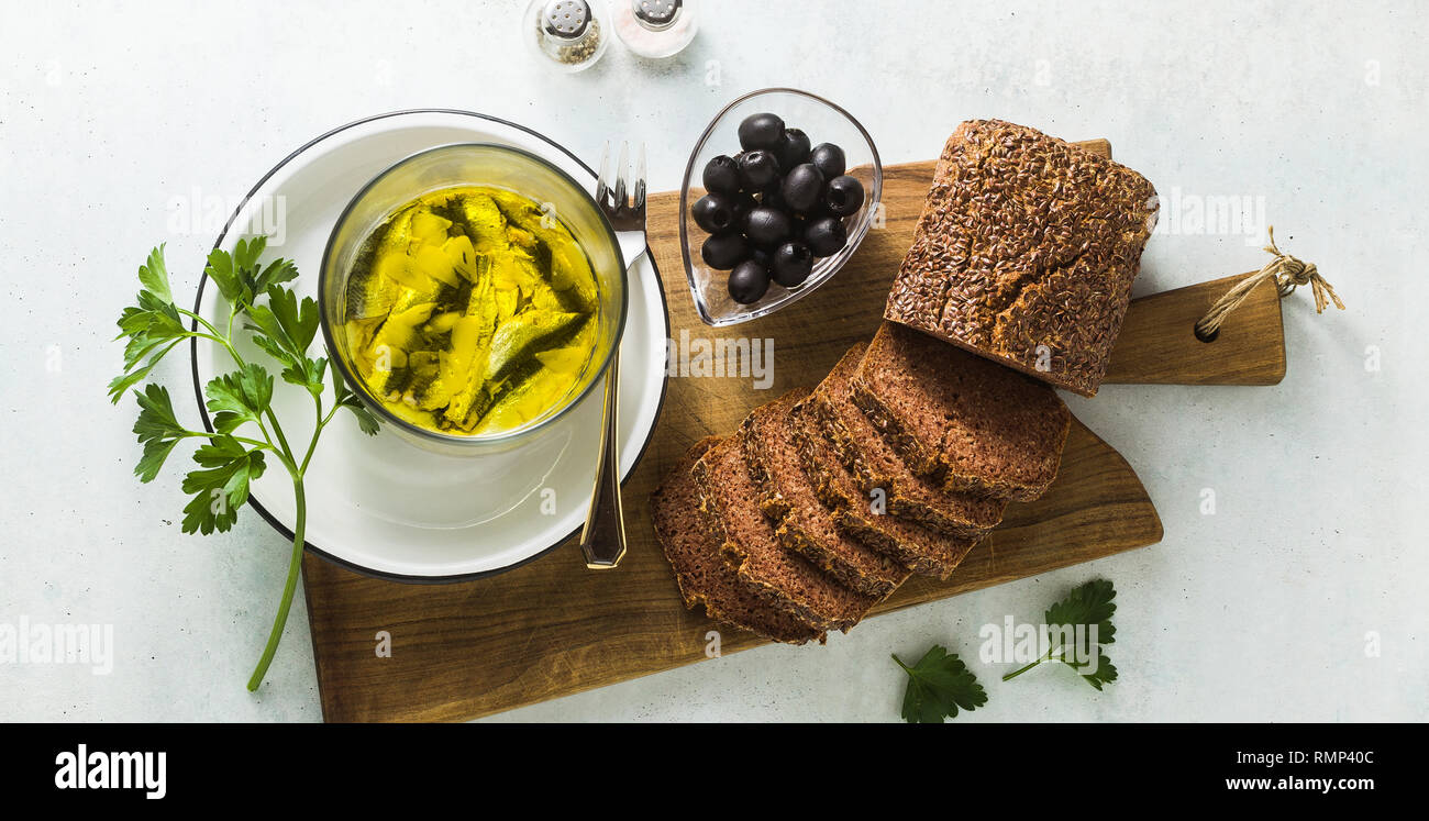 Banner di Sarde marinate in olio di oliva con pane di segale, il sale e il pepe sul tavolo. Italiano in casa napoletana cucina mediterranea ricetta. paglierino Foto Stock