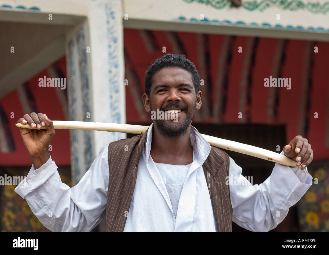 Ritratto di una tribù Beja uomo con un bastone di legno, rosso lo stato del Mare, Porto Sudan Sudan Foto Stock