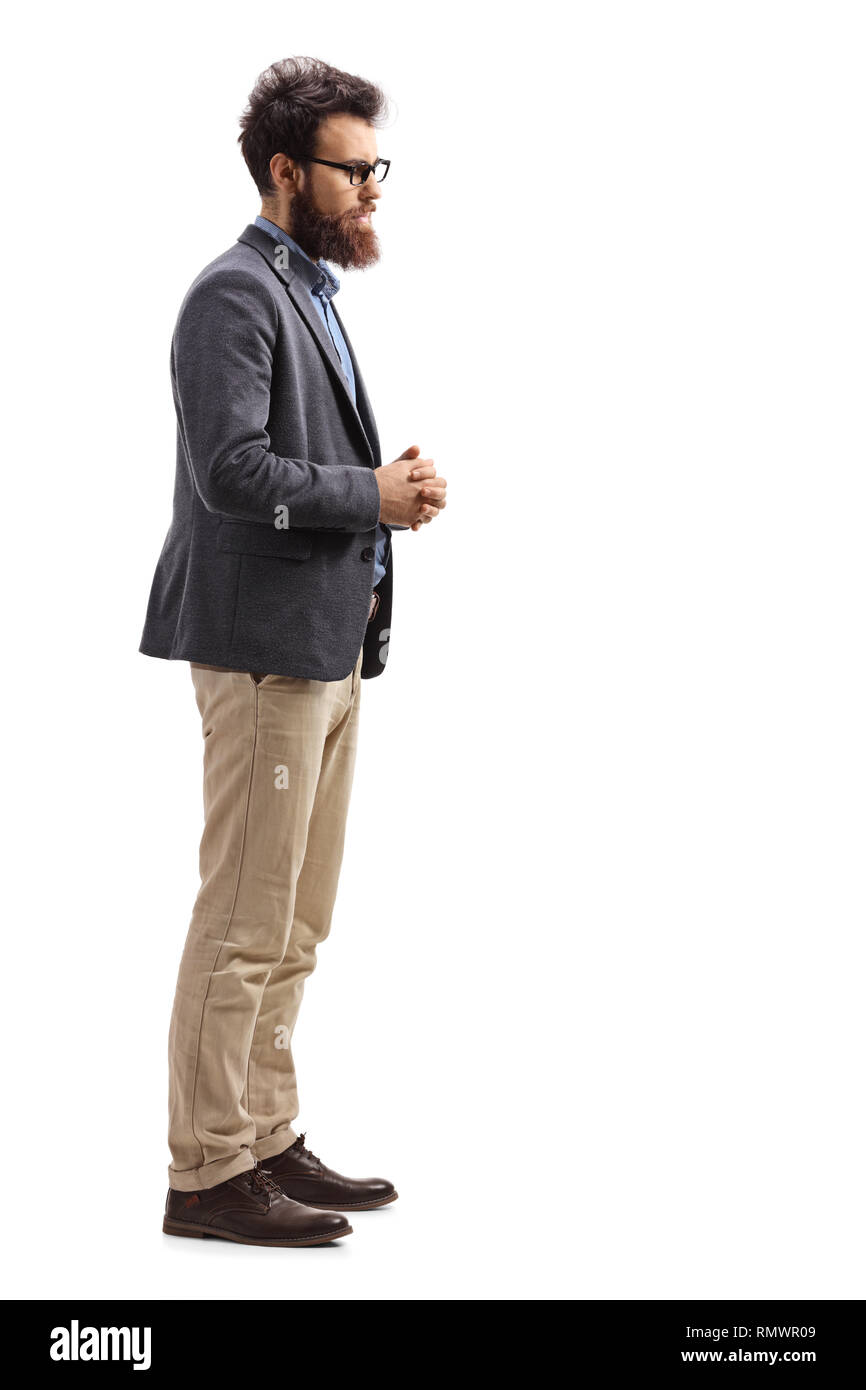Lunghezza piena ripresa del profilo di un uomo barbuto in piedi da solo e di ascolto isolato su sfondo bianco Foto Stock