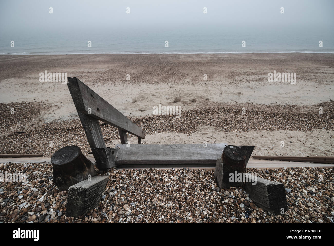 Gradini in legno andando giù per una spiaggia ghiaiosa Foto Stock