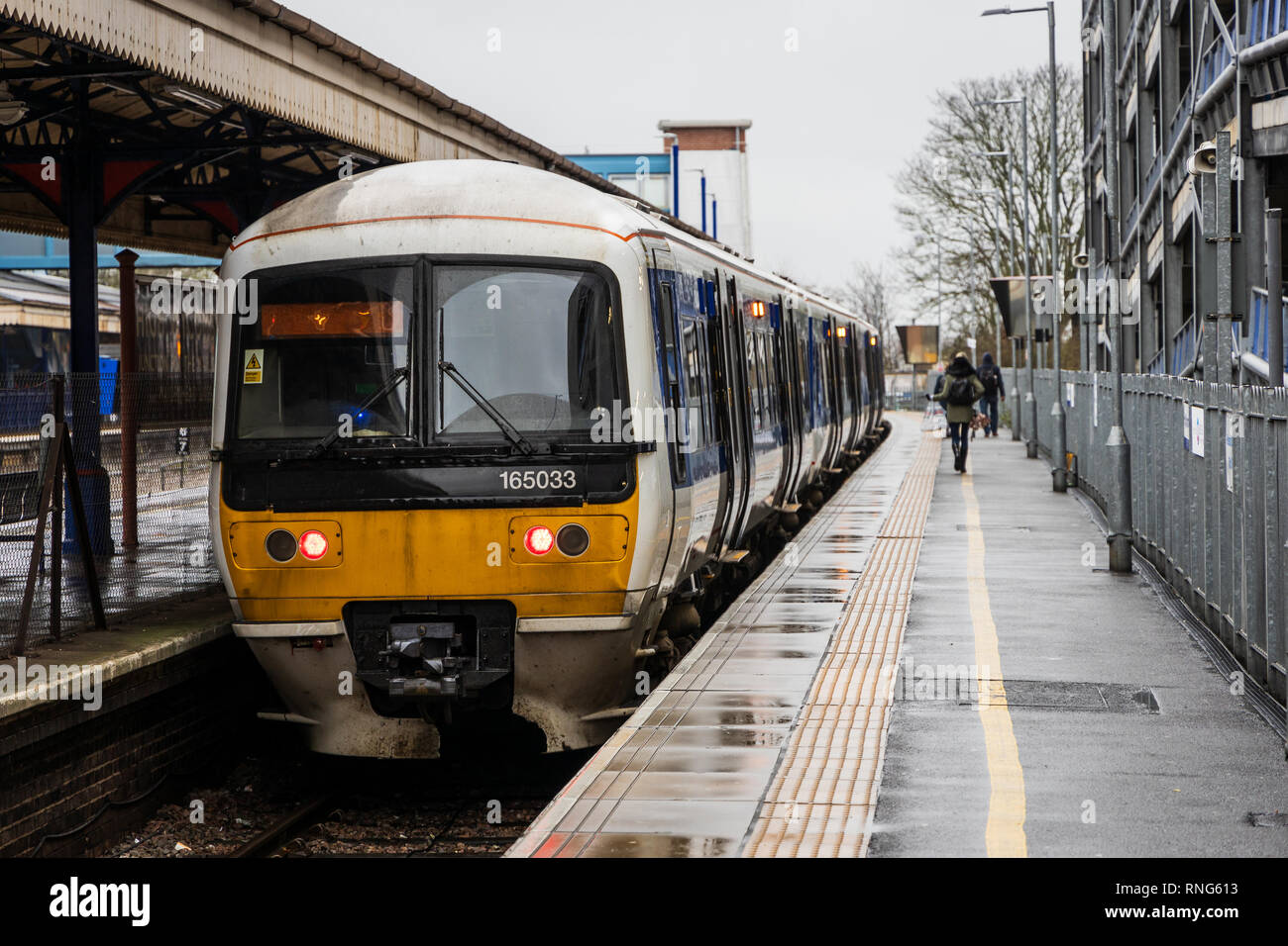 I pendolari sono in esecuzione su una piattaforma per una Chiltern Railways treno dalla stazione di High Wycombe stazione a Londra durante le ore di punta in una piovosa mattinata invernale Foto Stock