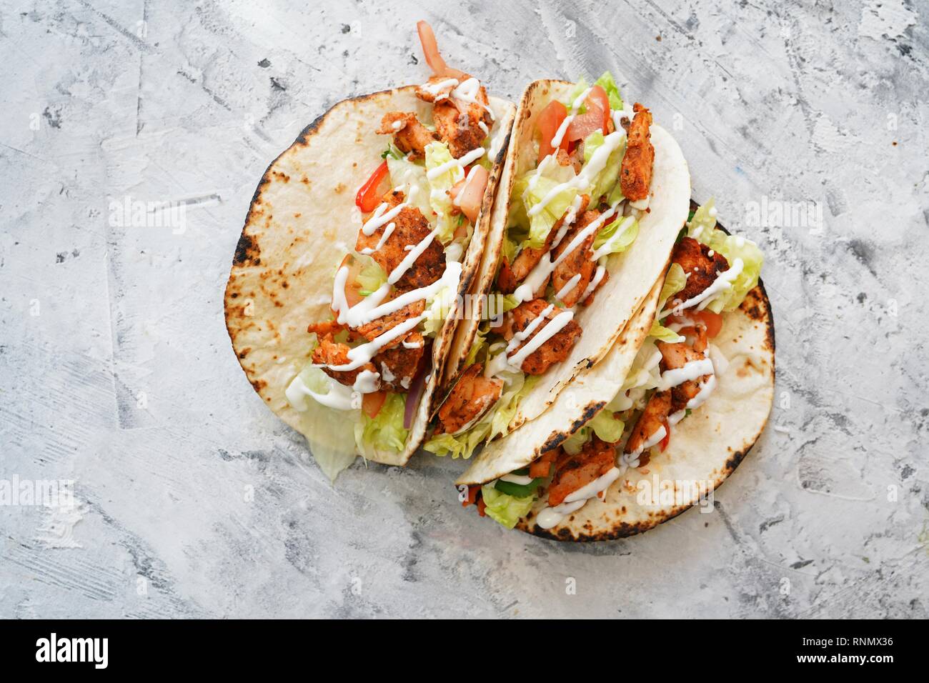 In casa il salmone grigliato pesce tacos una spruzzata di panna acida Foto Stock