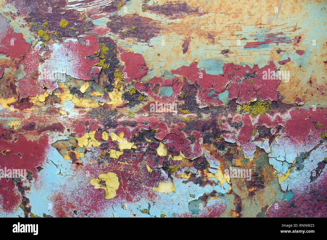 Smaltato superficie incrinato del cofano della vecchia auto è stata dipinta di giallo blu e rosso. Vintage concetto di texture Foto Stock