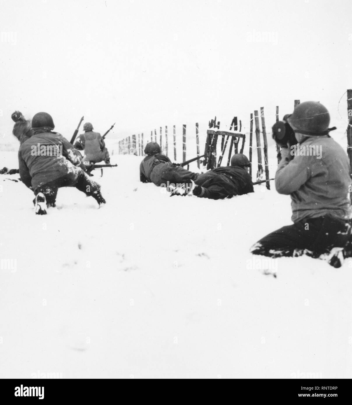 Una pattuglia, crescendo quando Lt. Thomas di cavalleria squadrone di ricognizione ha iniziato sulla neve con un fucile Granate, attacchi di cecchini tedesco scoperto nella periferia della nuova città catturate delle beffe, Belgio. Dodici Nazisti furono uccisi nell'impegno. Qui, può essere considerata parte della pattuglia avanzare con cautela attraverso la neve. Foto Stock