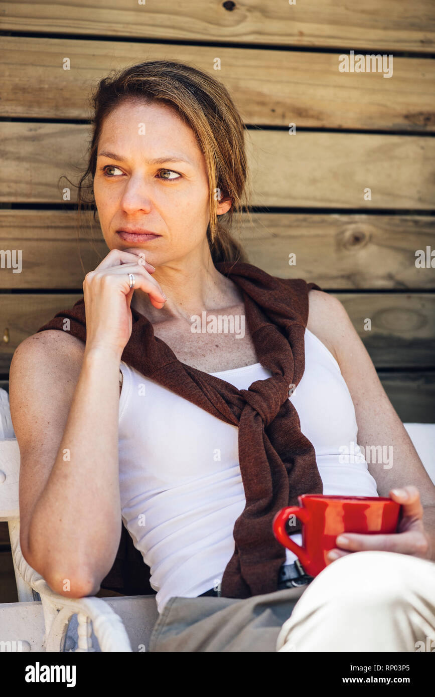 Donna matura seduti con la tazza di caffè Foto Stock