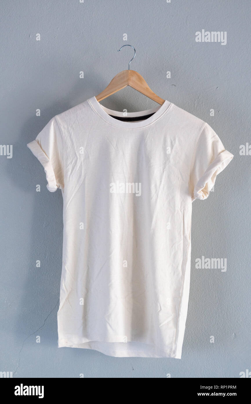 Retro bianco di piegatura T-shirt di cotone vestiti mock up modello sul cemento grigio concetto di sfondo per il retail dress shop sullo sfondo piatto vuoto laici grigio vintage Foto Stock