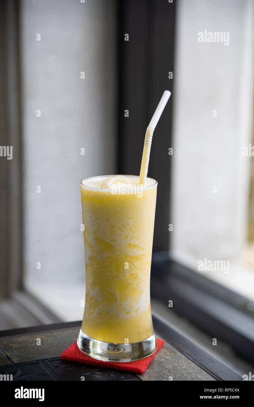 Bicchieri di succo di ananas sulla tabella classica con finestra spia Foto Stock