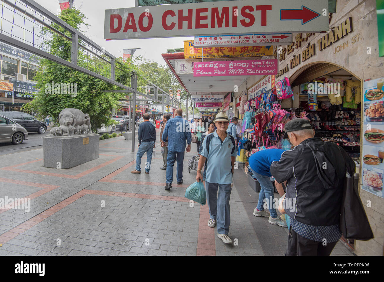 La gente camminare lungo John Street, Cabramatta passato uno dei molti negozi gestito dalla locale comunità vietnamita Foto Stock