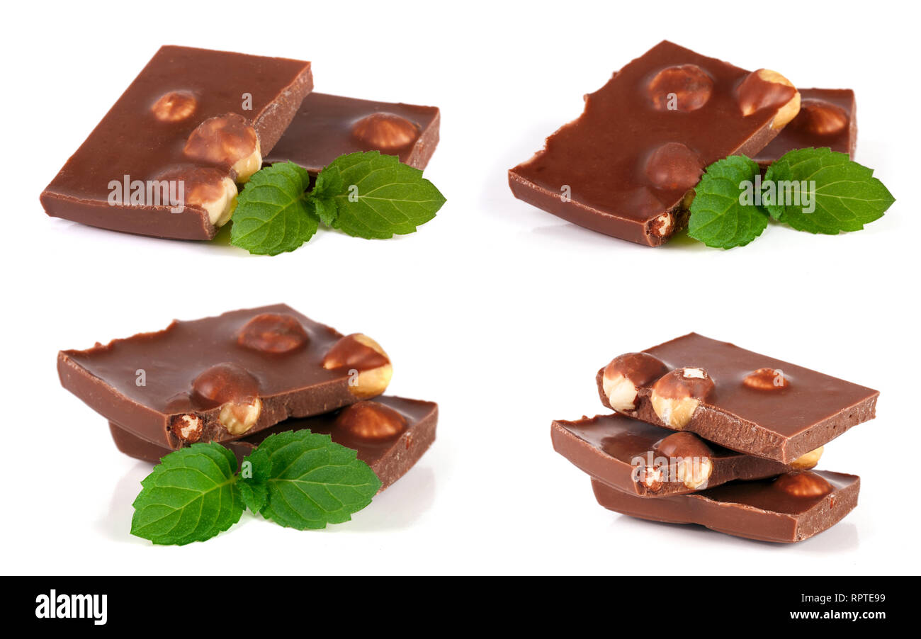 Il cioccolato con la nocciola e la foglia di menta isolati su sfondo bianco. Impostare o raccolta Foto Stock